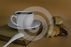 Cup of coffee and mini croissants with chocolate