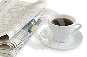A cup of coffee on a newspaper