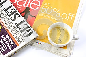 Cup of coffee on newspaper