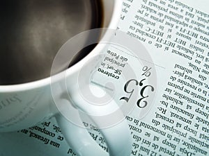 A cup of coffee and a newspaper