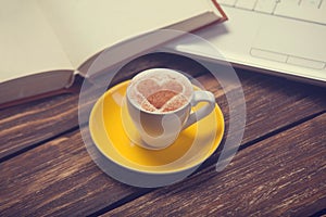 Cup of coffee and notbook