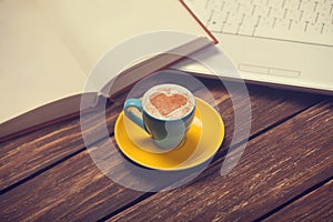 Cup of coffee and notbook