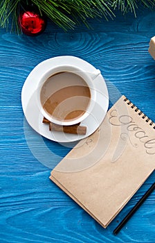 Cup of coffee and notebook with goals for new year