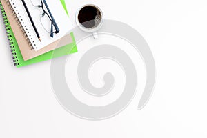 Cup of coffee with office tools on white background