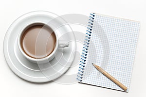 Cup of coffee, notebook and a pencil on a white table