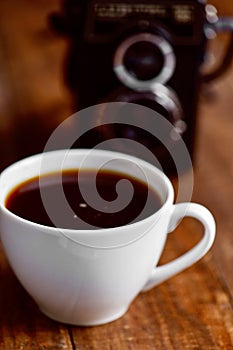 Cup of coffee and old camera