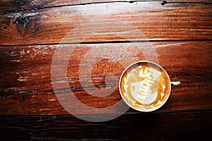 A cup of coffee on the old wooden table. Coffee shop, Thailand.