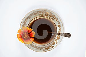 a cup of coffee with one red flower on the handle on a white background, coffee