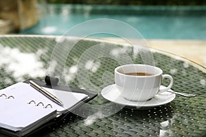 Cup of coffee, organizer and pen on a table