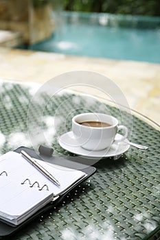 Cup of coffee, organizer and pen on a table