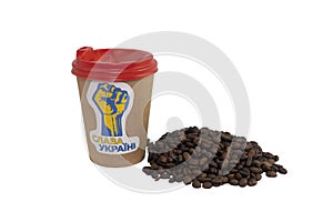 Cup of coffee with a patriotic sticker and a handful of roasted coffee beans isolated on a white background