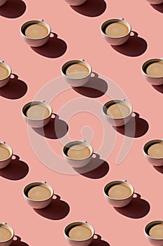 Cup of coffee pattern on pink background. Sunlight minimal trendy concept