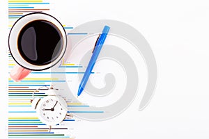 Cup of coffee with pen and clock on business charts and graphs. Business planning,accounting,analysis,financial planning and data