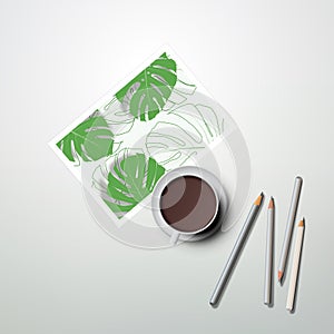 Cup of coffee, pencils and painting with tropical plants. Home office concept, study or freelance, working from home.