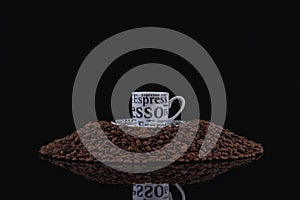 A cup of coffee on a pile of coffee beans