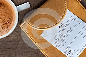 cup of coffee and receipt bill in folder payment