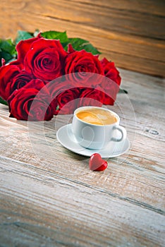 Cup of coffee and red roses