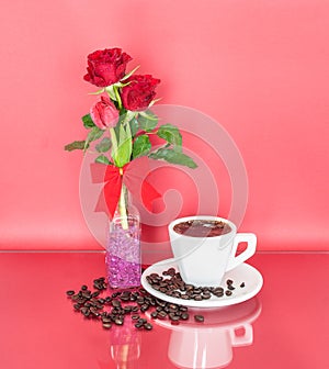 A Cup of Coffee and Red Roses in a Bottle