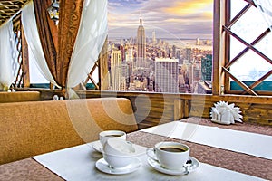 A Cup of coffee in a restaurant against the background of a beautiful landscape in the window