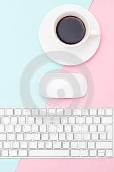 A cup of coffee on a rose-blue background. Vertical