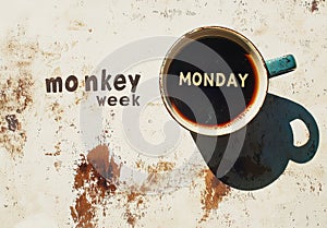 A cup of coffee on a rustic table with the word Monday symbolizing the start of the workweek photo