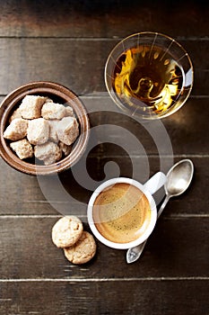Cup of coffee on rustic wooden background. Top view.