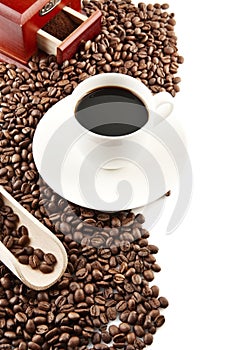 Cup of coffee with saucer and mill background photo