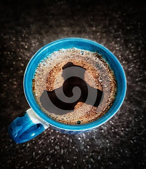 Cup of coffee on saucer with spoon