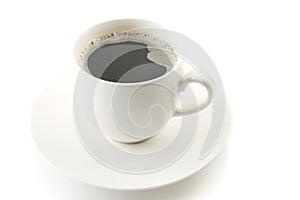 Cup of coffee with saucer on white