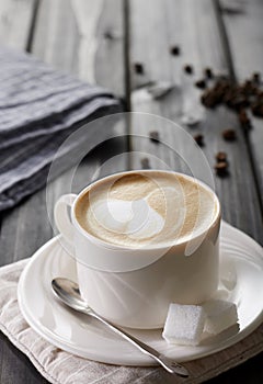 A cup of coffee and  saucer on the wooden table,latte art