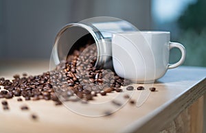 A cup of coffee and scattered coffee beans image