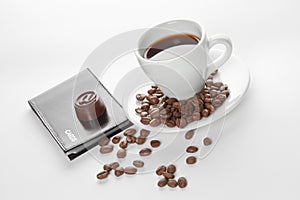 A cup of coffee, seeds, candy and cards