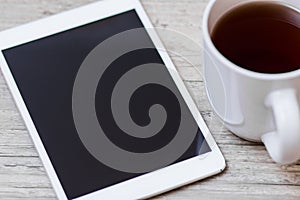 Cup of coffee, smart phone and tablet