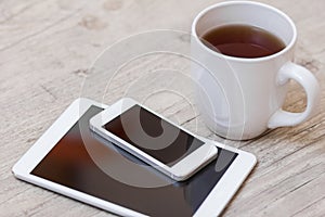 Cup of coffee, smart phone and tablet