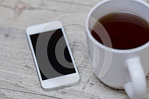 Cup of coffee, smart phone and tablet