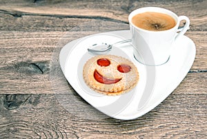 Cup coffee smiley face cookie. Funny breakfast