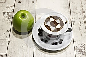 A cup of coffee with soccer ball