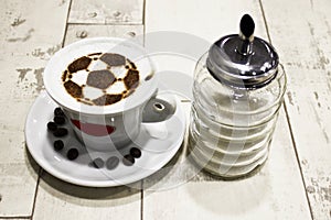 A cup of coffee with soccer ball