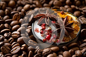 Cup of coffee with spices among coffee beans