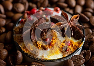 Cup of coffee with spices among coffee beans