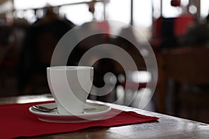 Cup of coffee with spoon on table