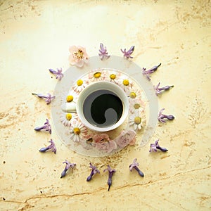 A cup of coffee with spring flowers