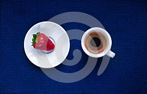 Cup of coffee and a strawberry