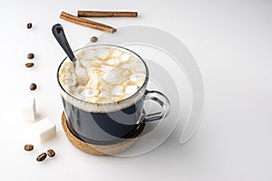 Cup of coffee, suger cubes, coffee beans, marshmallows and cinnamon sticks