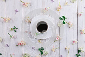 Cup of coffee surrounded with flowers