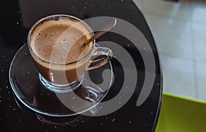 Cup of coffee on table in cafe