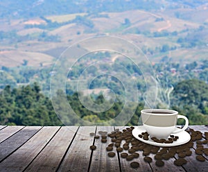 Cup with coffee on table over mountains