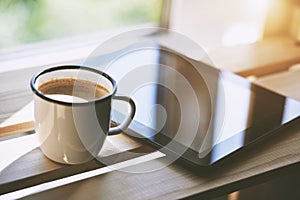 Cup of coffee with tablet computer