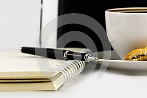 Cup of coffee,tablet computer,book and pen