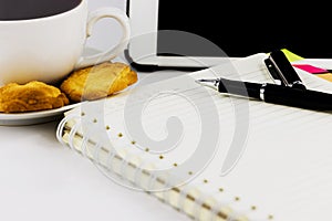 Cup of coffee,tablet computer,book and pen